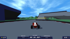 PolyTrack red race car travelling at high speed toward a steep elevated ramp